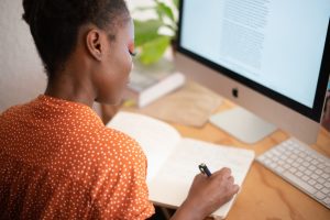 English tutoring with computer desk woman writing Chatsfieds Learn english faster