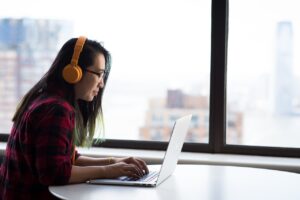 A female student taking her english listening practice lessons on chatsifieds
