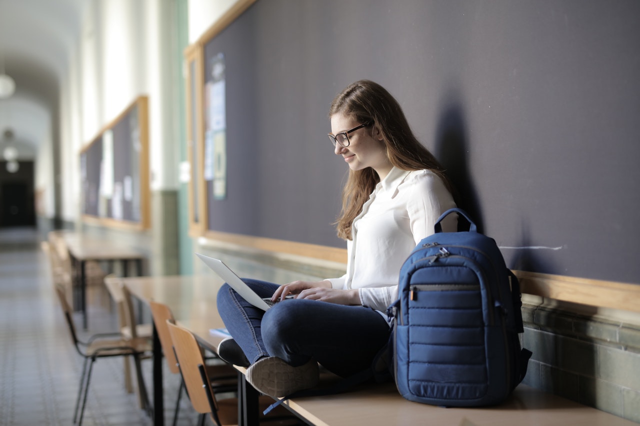 Girl Studying English with a laptop on her lap